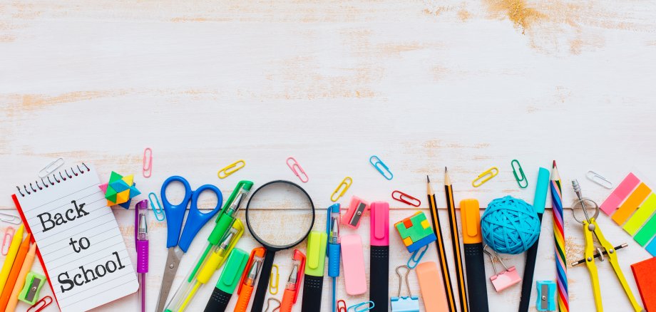 School supplies on rustic wooden table.